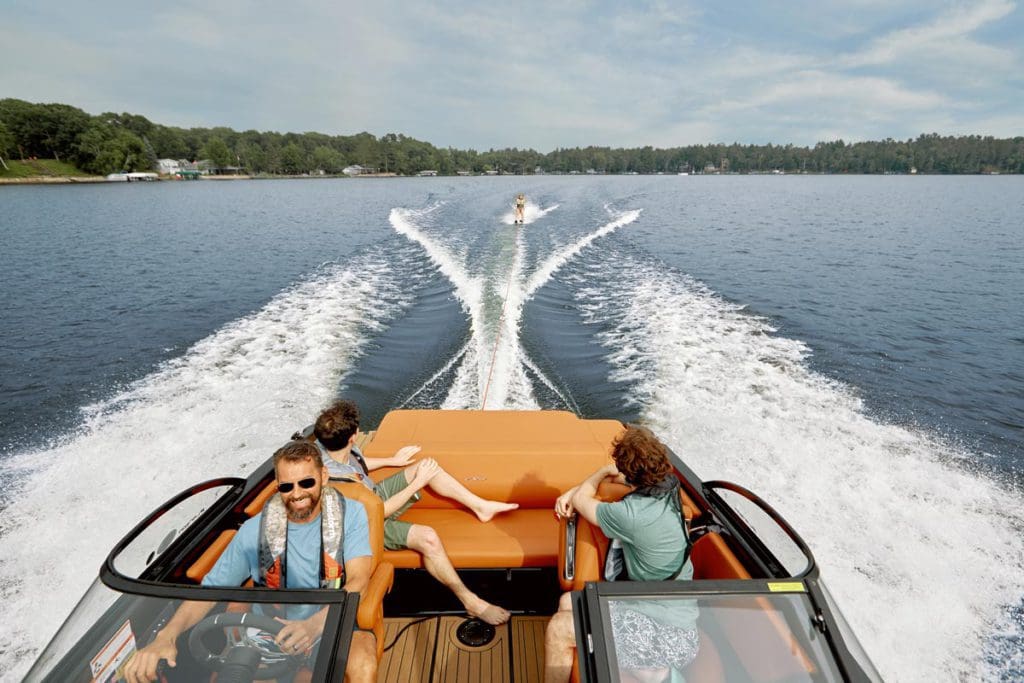 Several people enjoy a speedboat ride across Gull Lake.
