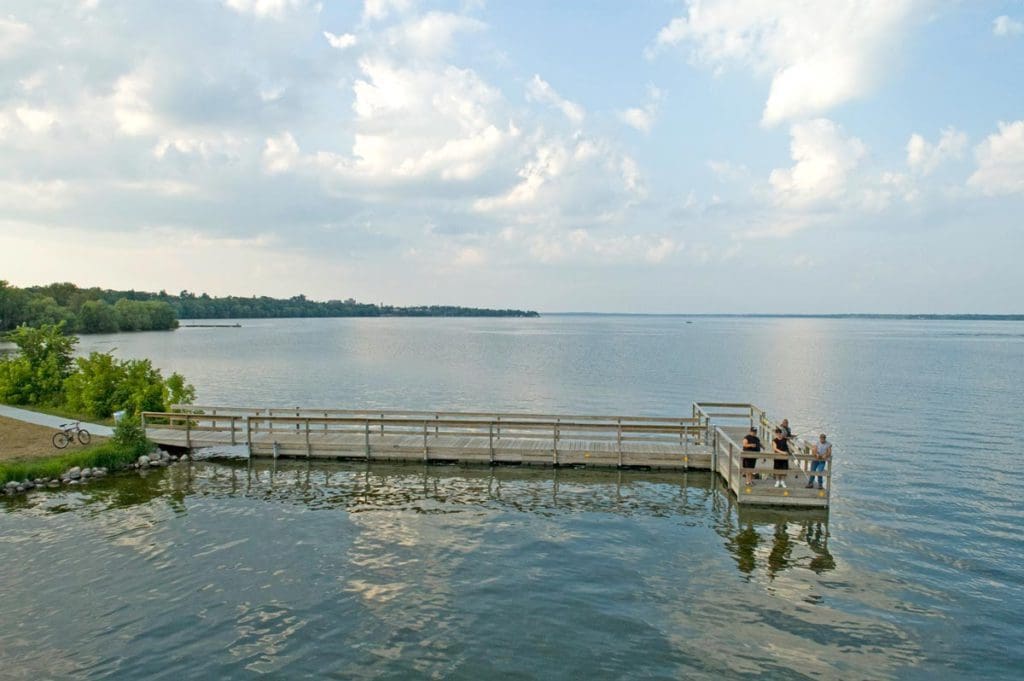 Sever people fish from a dock on Lake Bemidji.