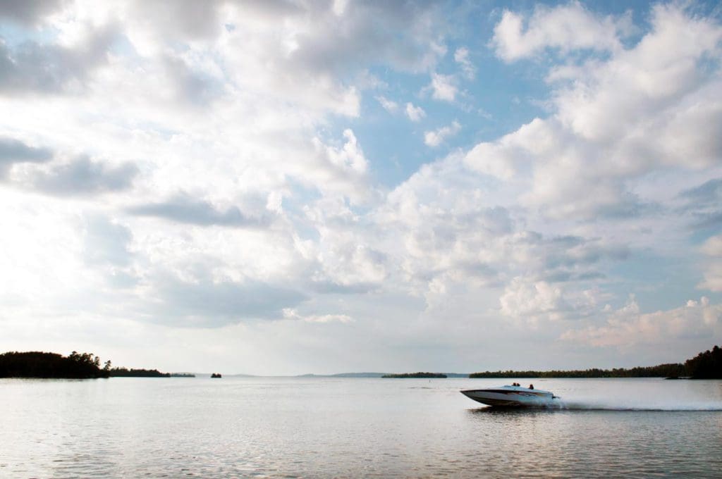 A speedboat zooms across Lake Vermilion, one of the best lakes in Minnesota for families.