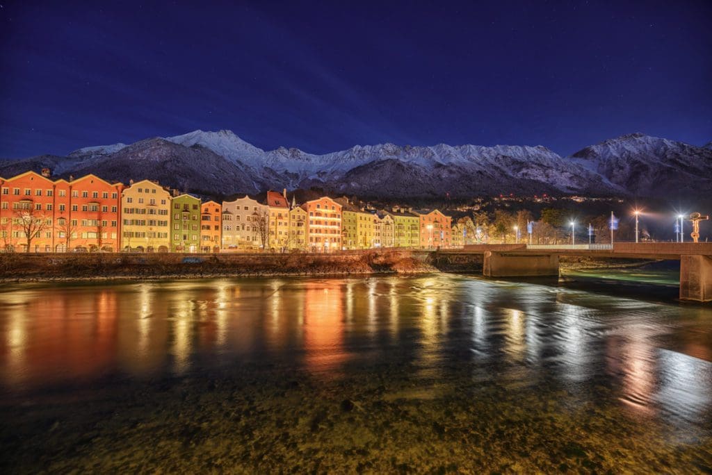 A lovely view of Maria-Hilf row of houses at night, all lit up along the river.