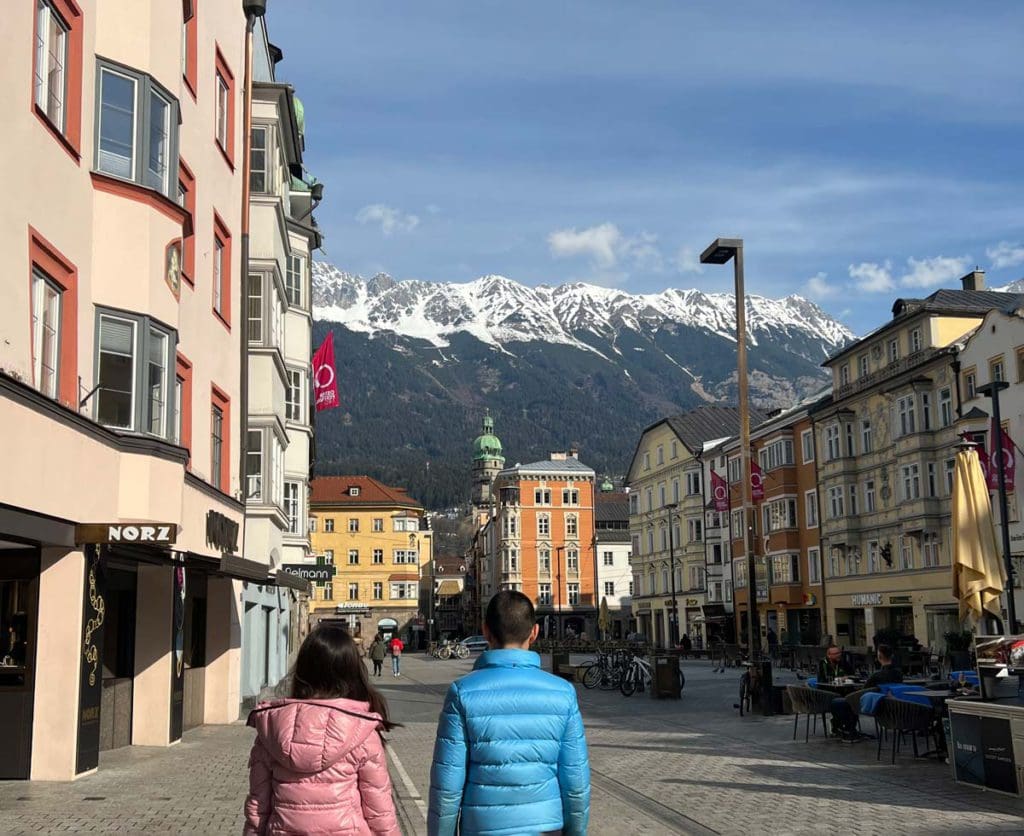 Two kids look toward Innsbruck's historic old town, while exploring the city as a family.
