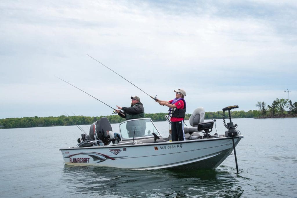 A family fishing on Mille Lacs Lake in Minnesota, one of the best places for a Midwest family fishing vacation. 