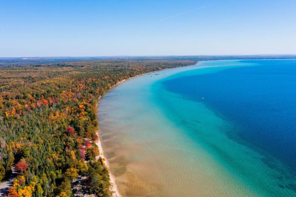 Aerial view of Higgins Lake, with clear blue waters.