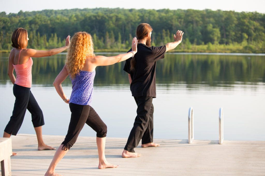 An instructor leads two women in ta chi at The Lodge at Woodloch, a weekend away is one of the best travel gifts for Mom this Christmas.