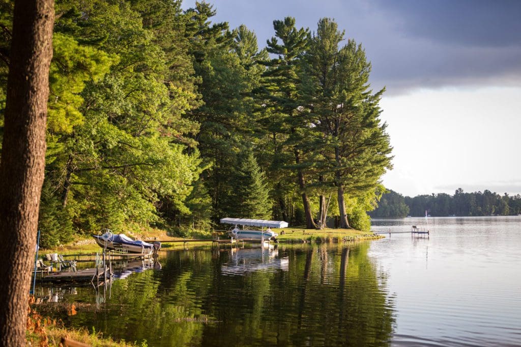 A shoreline view of Minocqua Lake, featuring a few lakeside docks.