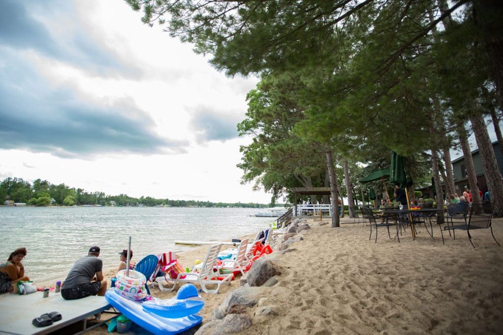 Families enjoy a lovely afternoon a beach at Silver Lake, one of the best places to rent a lake house in Wisconsin with kids.