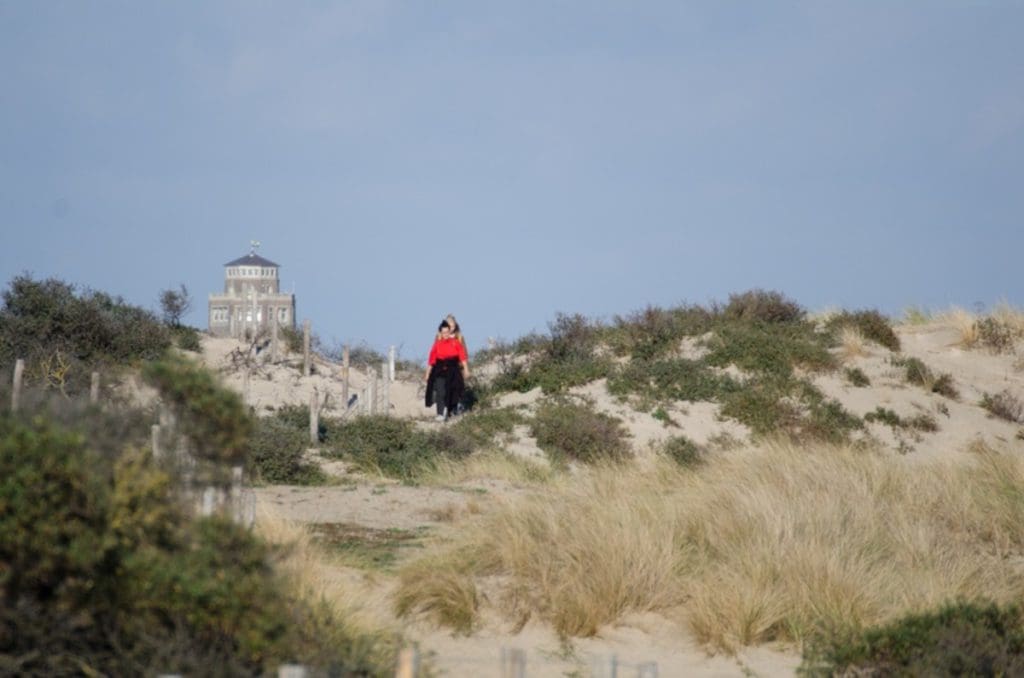 A group of women walk on a path through the sand dunes of Zandvoort, the Netherlands.