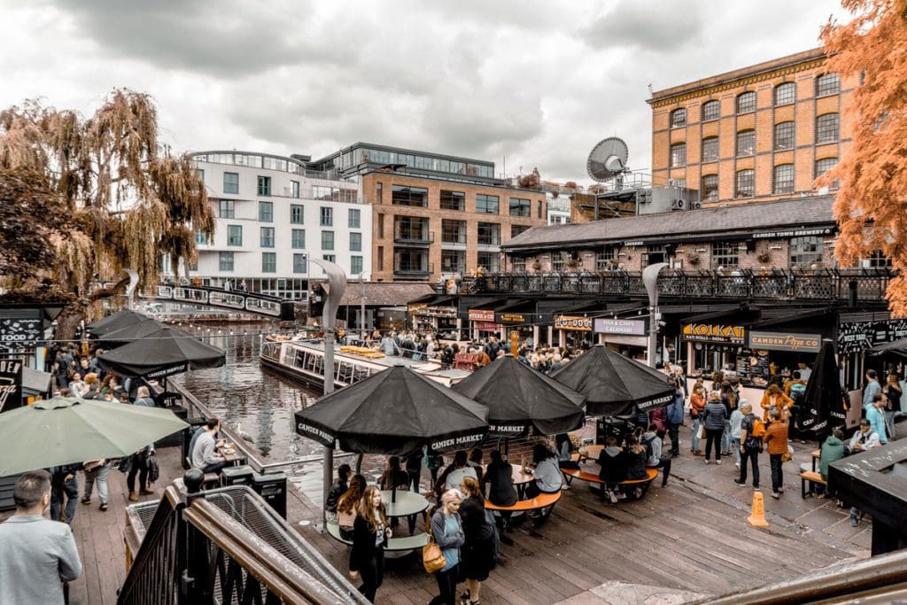 An aerial view of a busy section of the Camdem Market, featuring travelers dining and shopping.