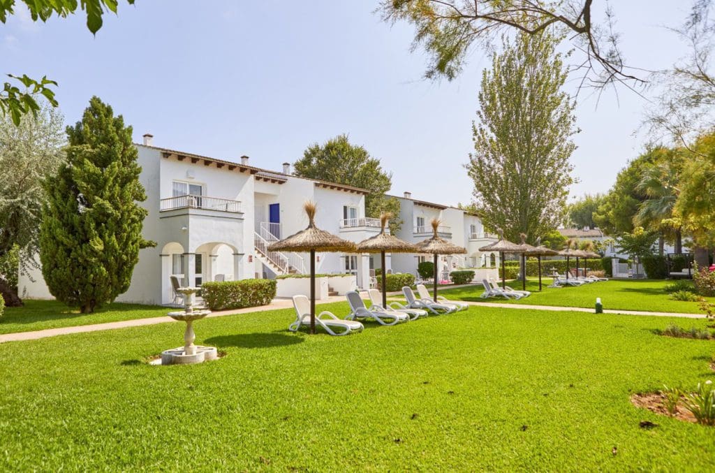 Outdoor cabanas line the apartments of Sea Club Alcudia Mediterranean.