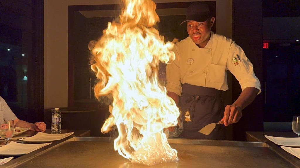 A chef prepares a hibachi-style dinner.