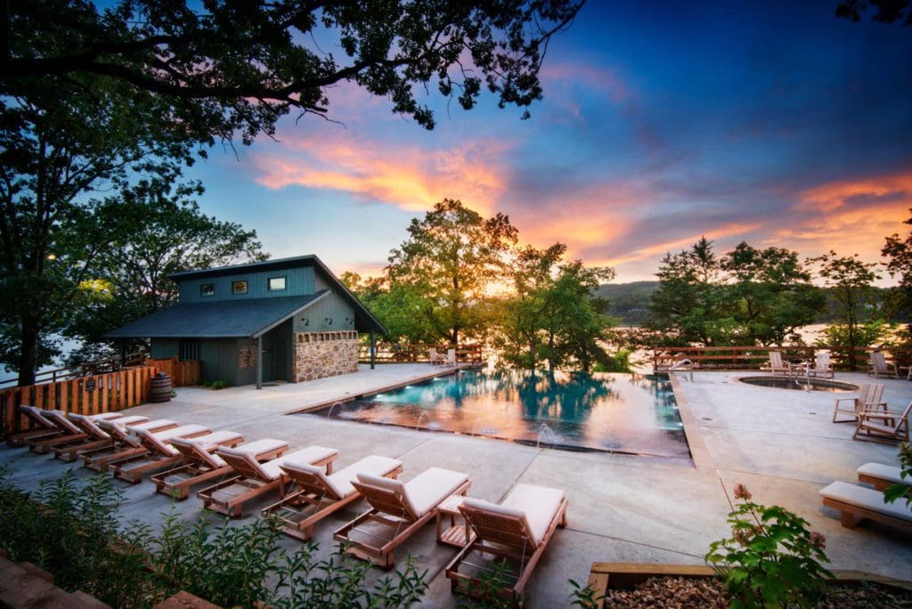 The outdoor pool and surrounding pool deck at Big Cedar Lodge at dusk, one of the best Moms Weekend Getaways in the Midwest.