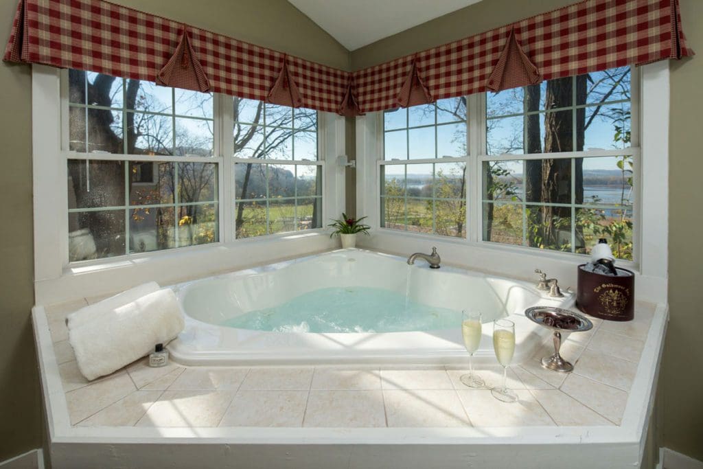A jetted tub in one of the suites at Goldmoor Inn & Resort with a beautiful view out the window at one of the best Moms' Weekend Getaways in the Midwest.