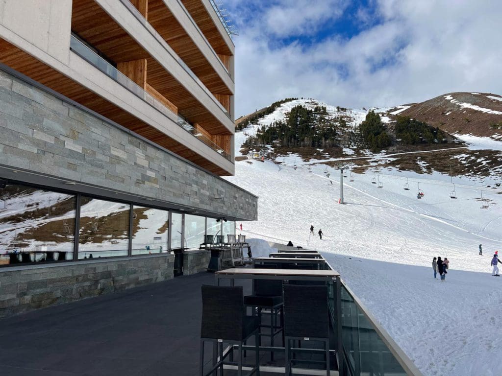 The outdoor terrace at Hotel Mooshaus, facing the snowy slopes of Kühtai Ski Resort.
