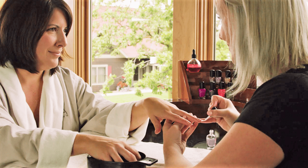A woman receives a manicure at Madden’s On Gull Lake, one of the best Moms' Weekend Getaways in the Midwest.