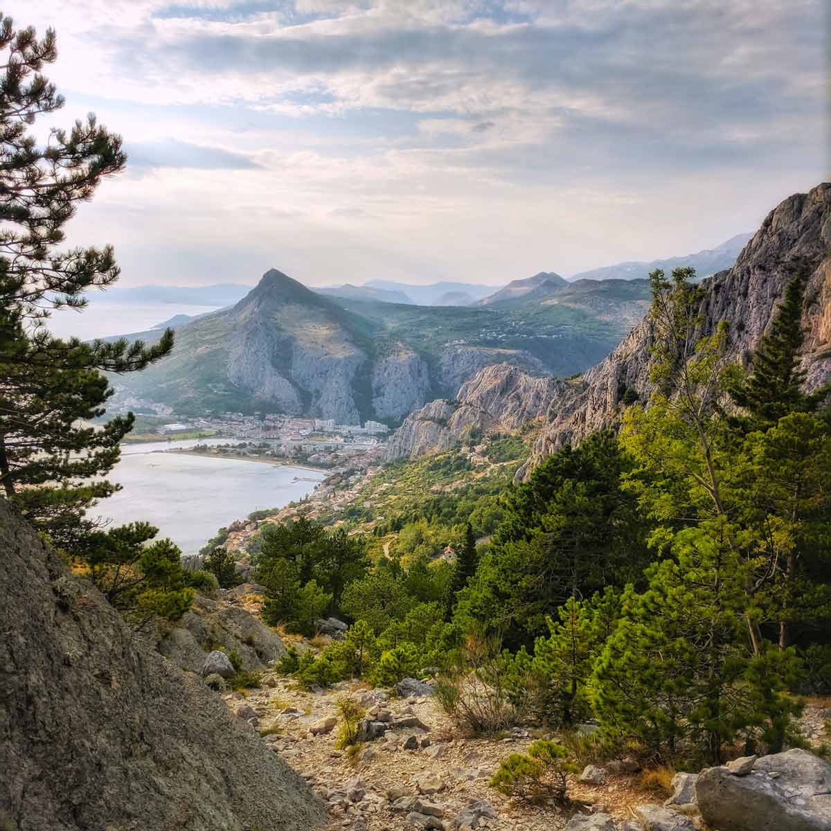 A picturesque scene of mountains and a lake near Omis, one of the best places to visit in Croatia with kids this summer.