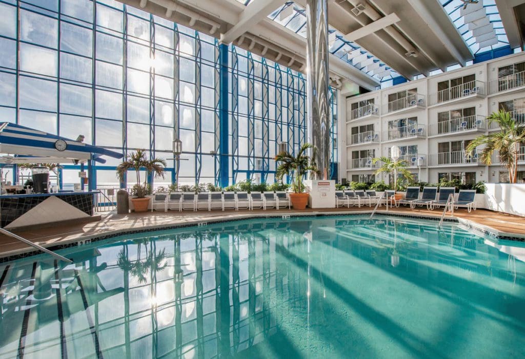 The beautiful indoor pool area, with floor to ceiling windows, at Princess Royale Oceanfront Resort.