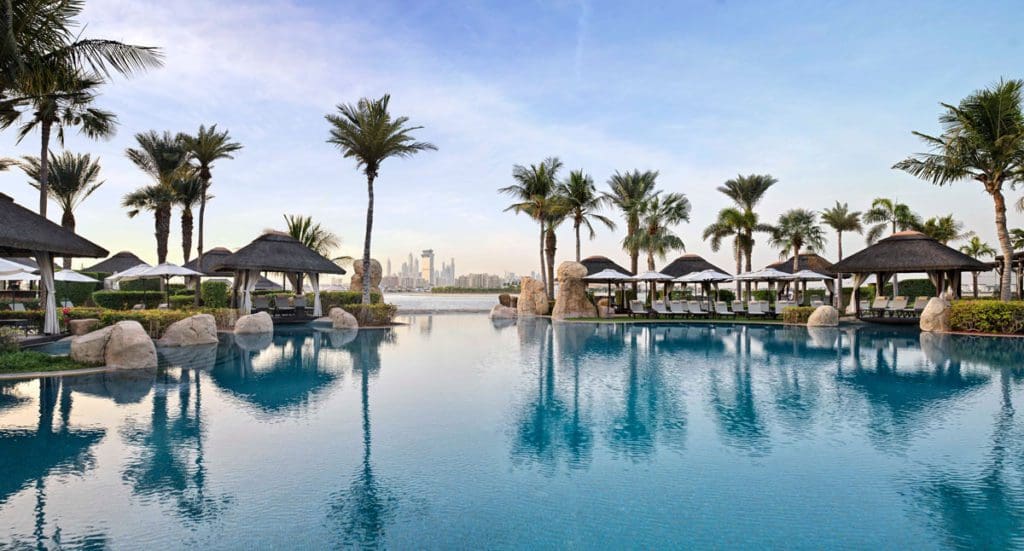 A beautiful pool, surrounded by palm trees, at Sofitel Dubai The Palm.