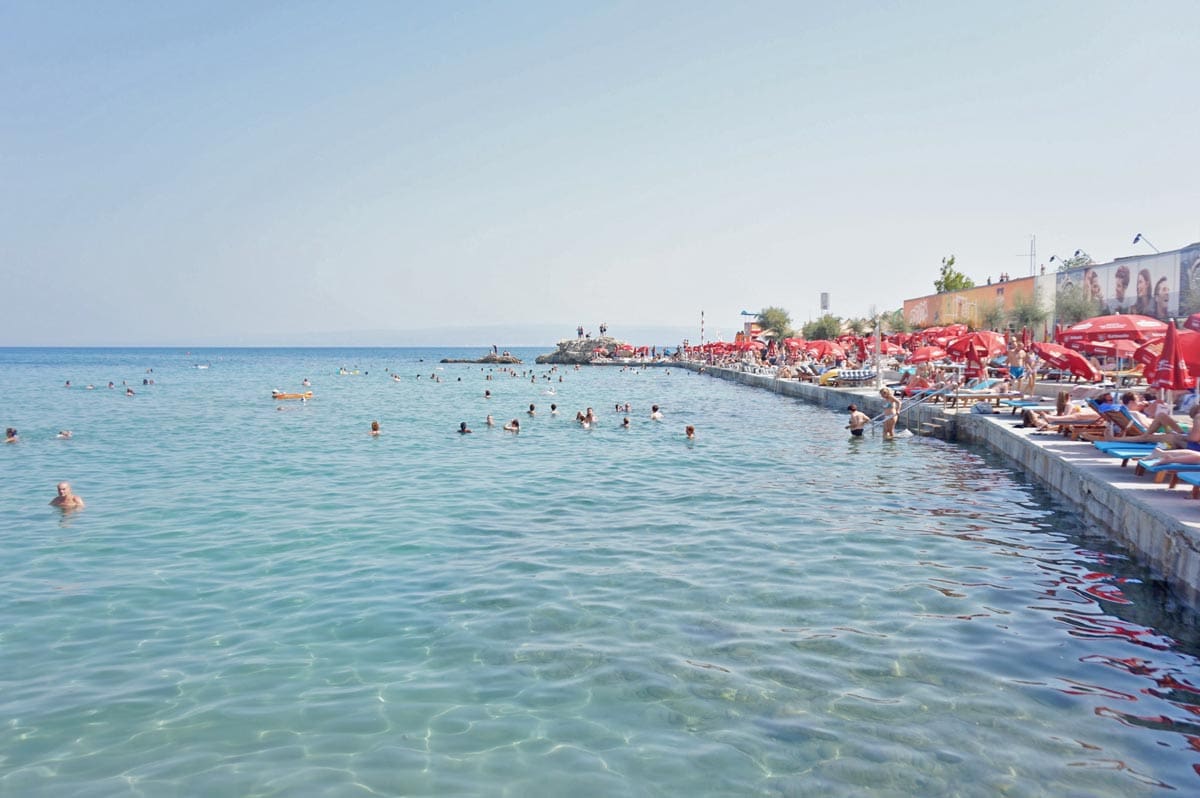 A beautiful shoreline filled with people enjoying the sun in Split, one of the best places to visit in Croatia with kids this summer.