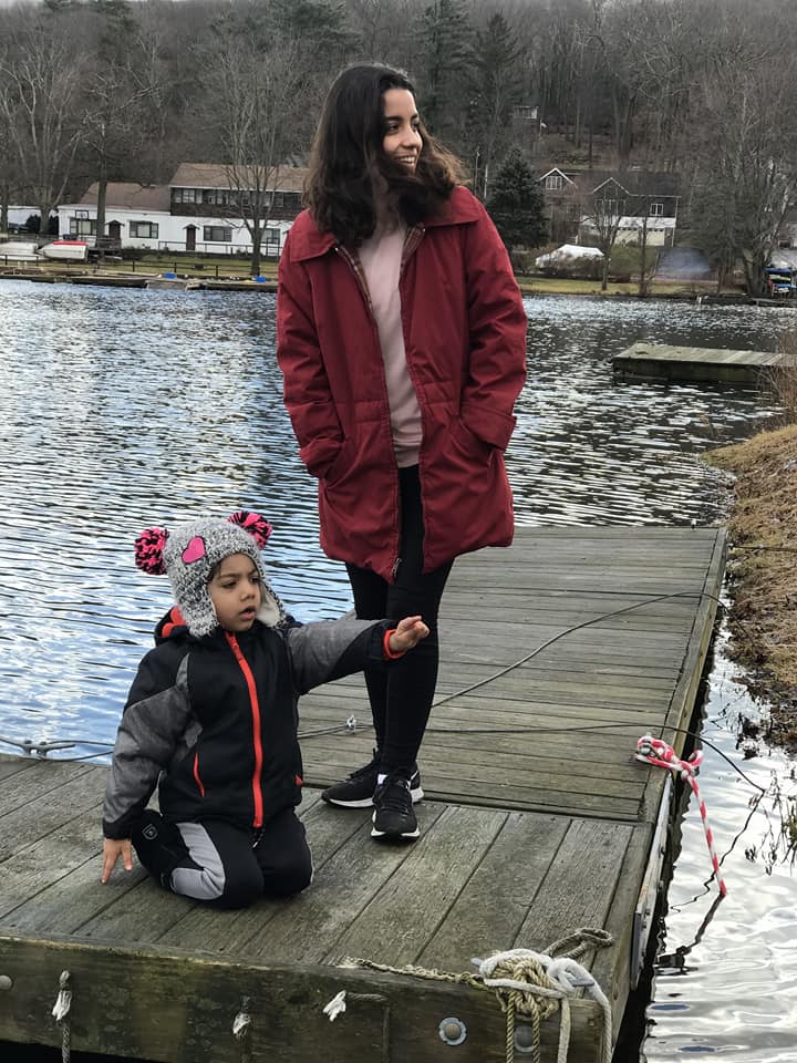 A mom and her young son stand on a dock on Greenwood Lake.