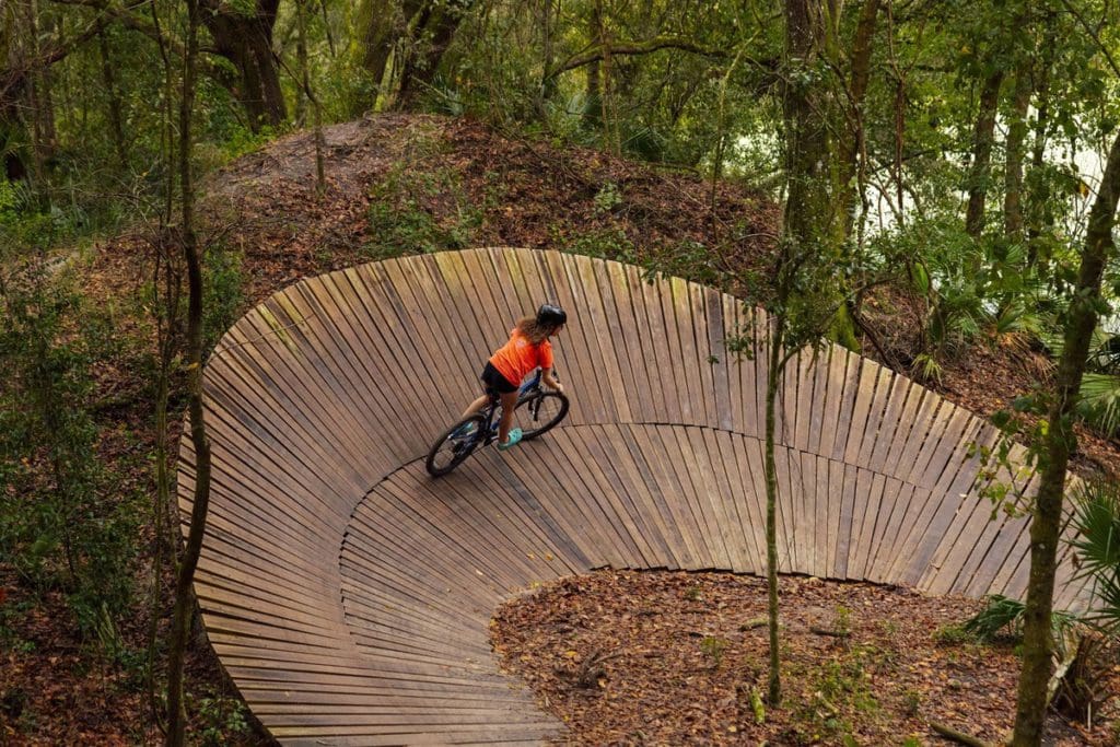 A mountain biker zooms along a path in Alafia River State Park.