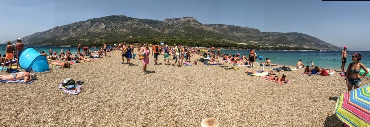 People enjoy a sunny day on the beach in Brač, one of the best places to visit in Croatia with kids this summer.
