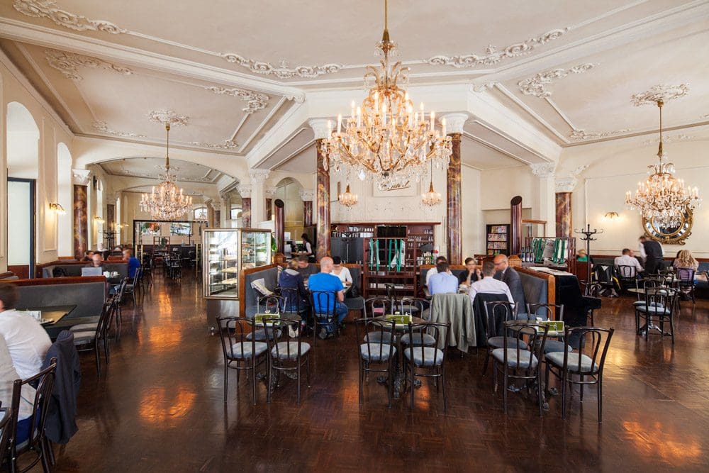 Inside the luxurious dining area, with chandeliers, at Hotel Central - Innsbruck, one of the best hotels in Innsbruck for families.