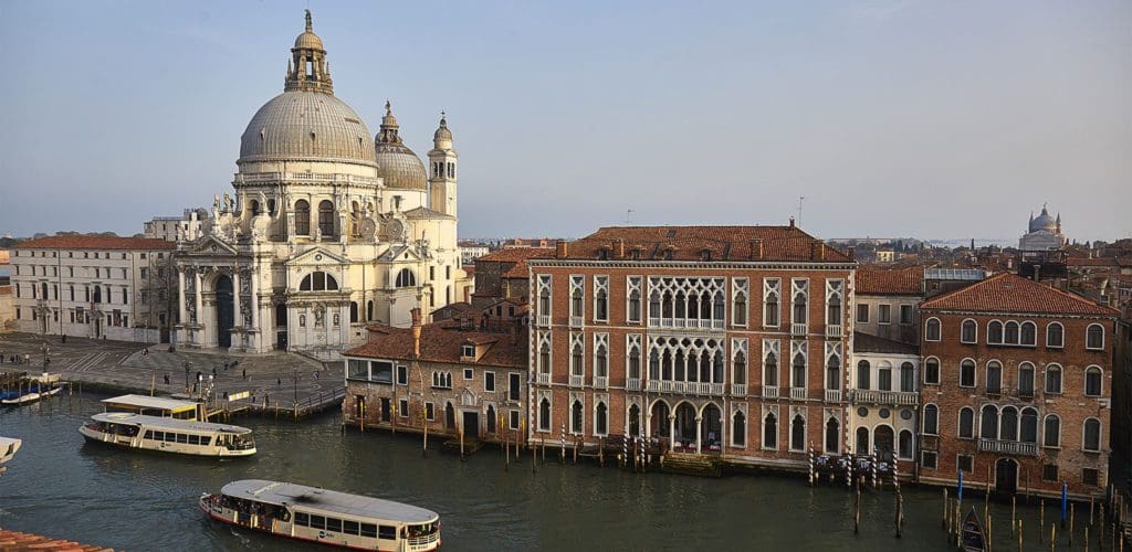 The exterior of Sina Centurion Palace along a canal in Venice.