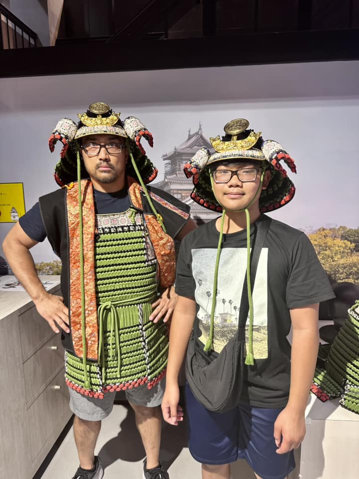 Two kids dress in traditional Japanese wear while visiting the castle in Osaka.