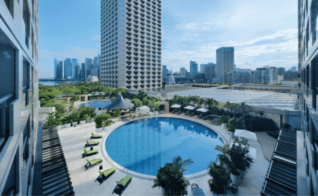 An aerial view of the outdoor pool and pool deck at Fairmont Singapore.