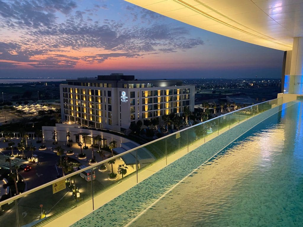 An aerial view of the adult pool at WB Abu Dhabi, Curio Collection by Hilton, from a guestroom balcony.