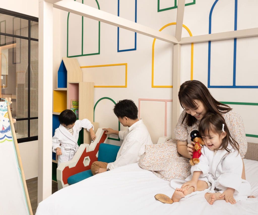 A family playing in a family suite at Grand Park City Hall.