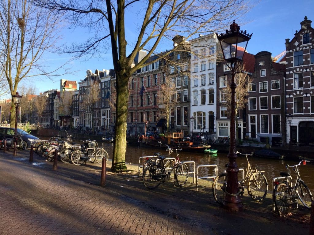 Bikes parked along a road in Amsterdam.