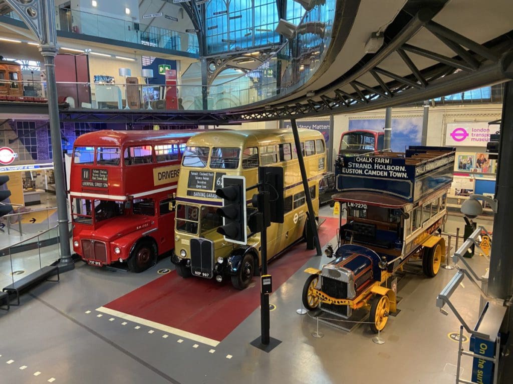 Several large buses inside the London Transport Museum.