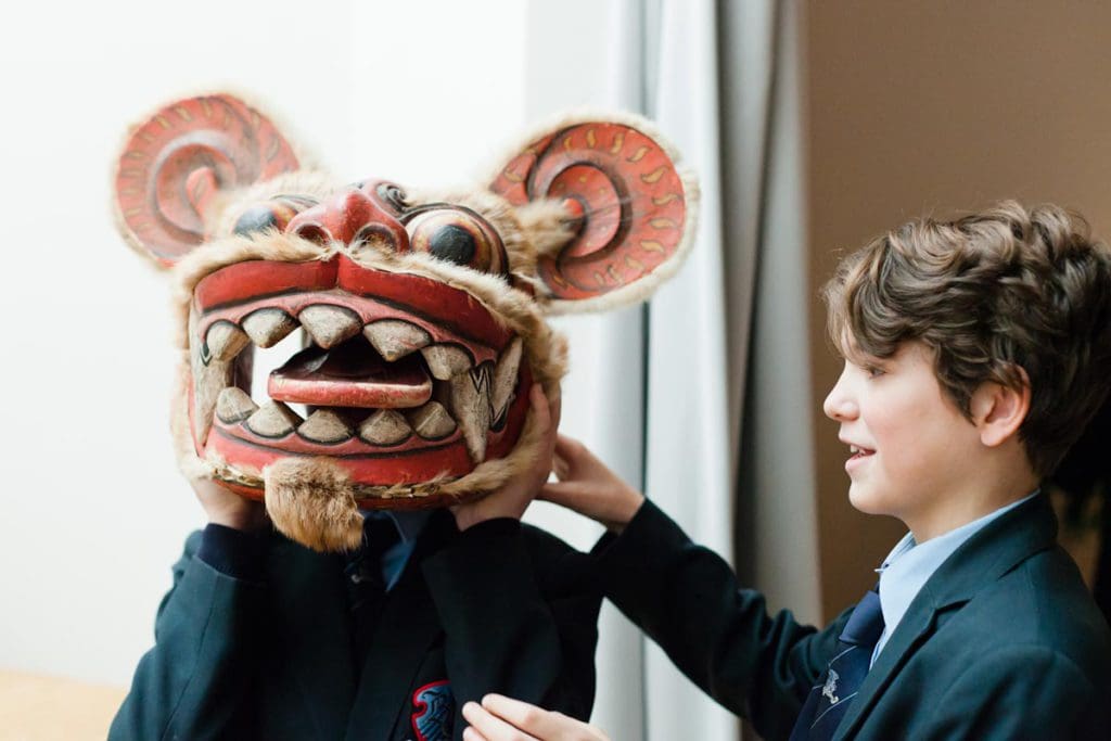 Two young boys enjoys a mask exhibition at Horniman Museum and Gardens.