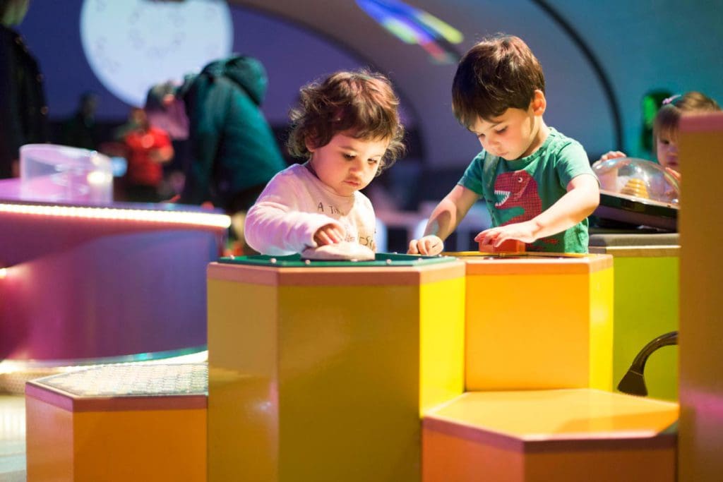 Two young kids play together at the Pattern Pod at The Science Museum, one of the best museums in London for kids.