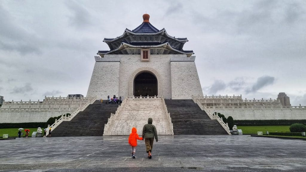 Two kids stand in front of a temple in Taipei, one of the best places to visit in Asia with kids.