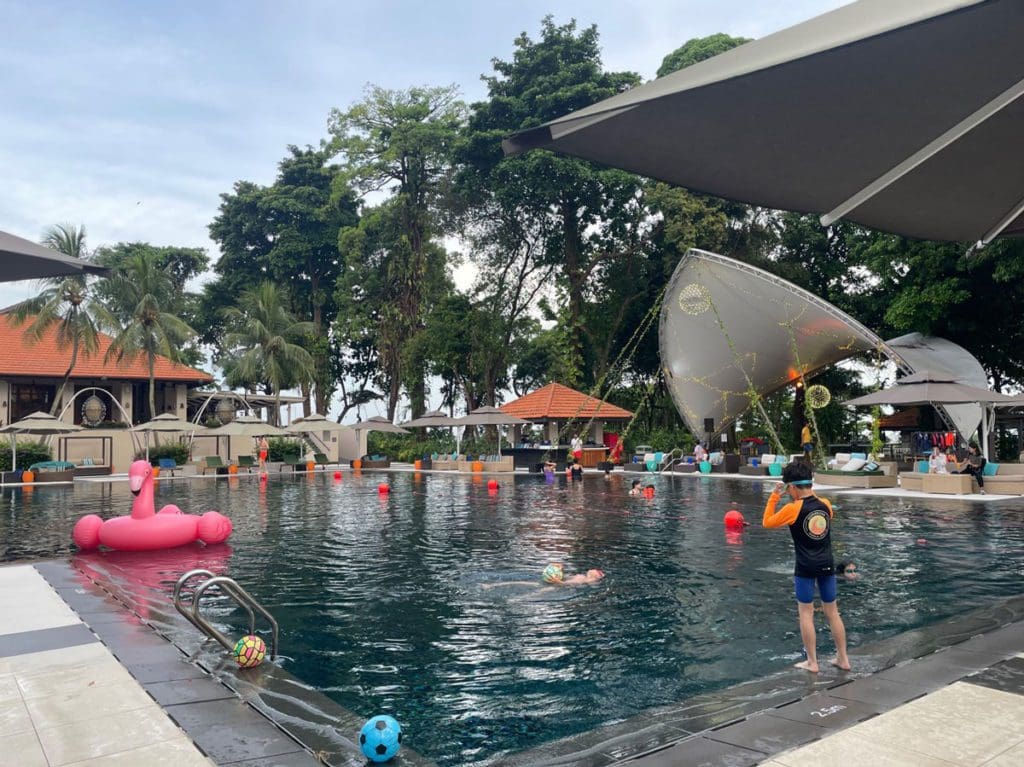Kids playing in the outdoor pool at Sofitel Singapore Sentosa Resort & Spa.