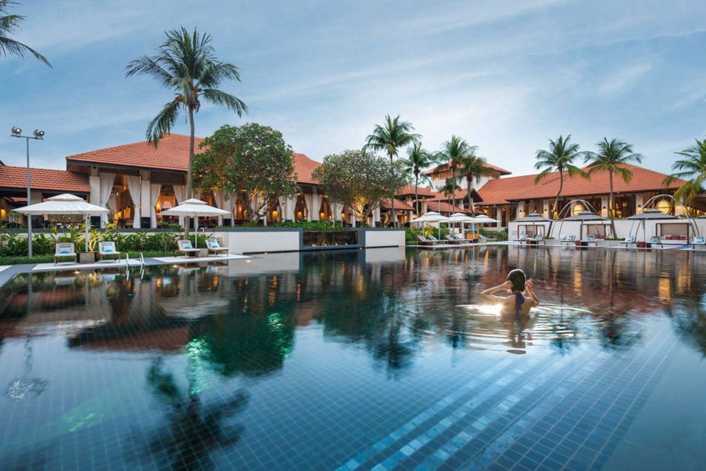 The outdoor pool and surrounding cabanas at Sofitel Singapore Sentosa Resort & Spa.