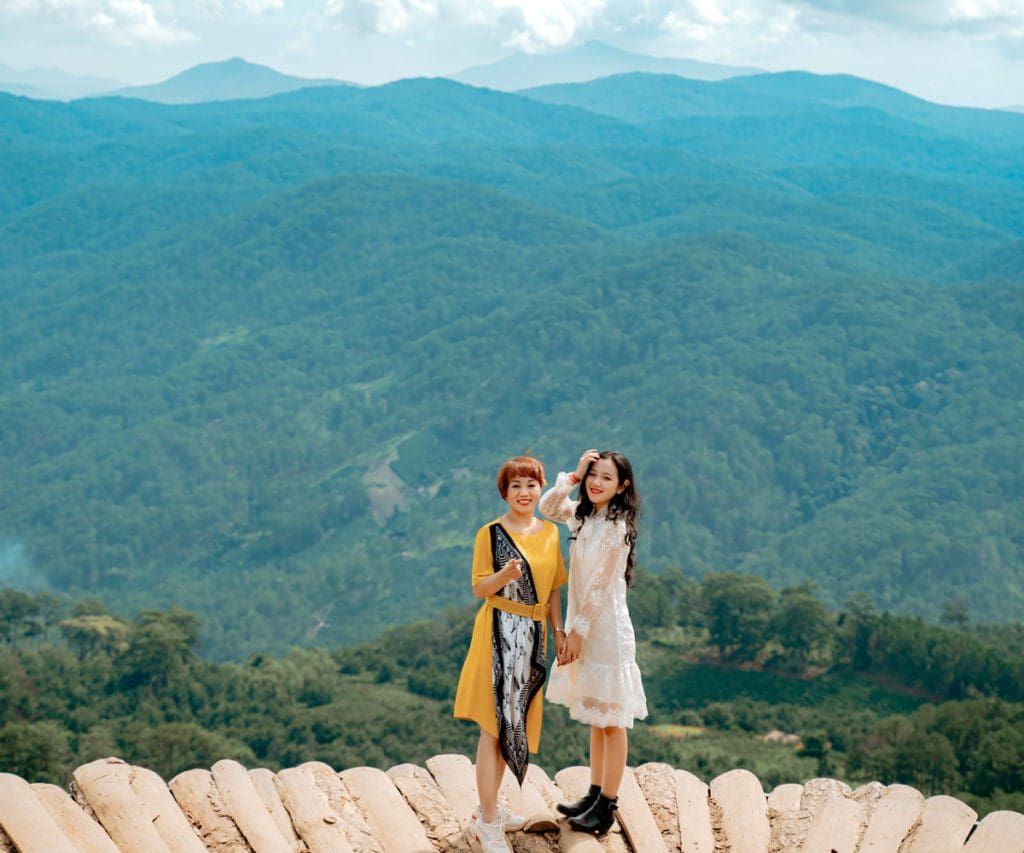 A woman and her mother stand atop a mountain together in Asheville.