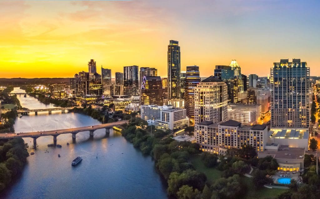 An aerial view of Austin, Texas, along the river at dusk.