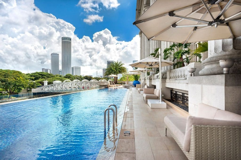 The outdoor pool and pool deck at Fullerton Bay Hotel, one of the best hotels in Singapore with kids.