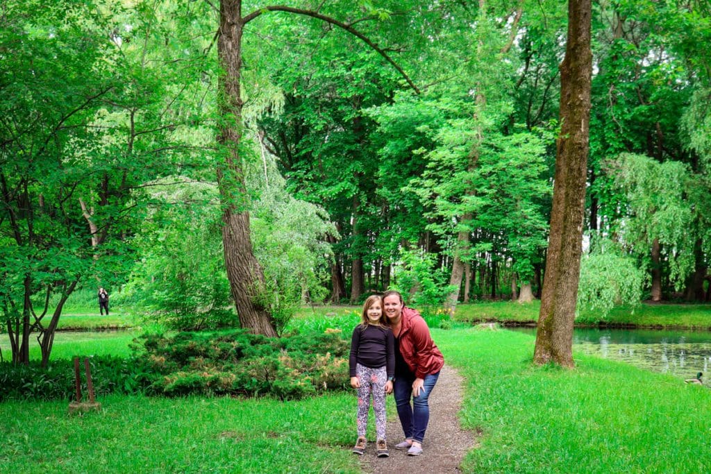 A young girl and her daughter stand together on an island at Domaine de Maizerets, a must do on any Quebec City itinerary with kids.