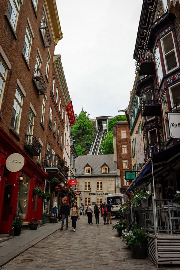 A view down a street in the Petit Champlain Quarter, looking toward the entrance to the funicular, a must see on any Quebec City itinerary with kids.