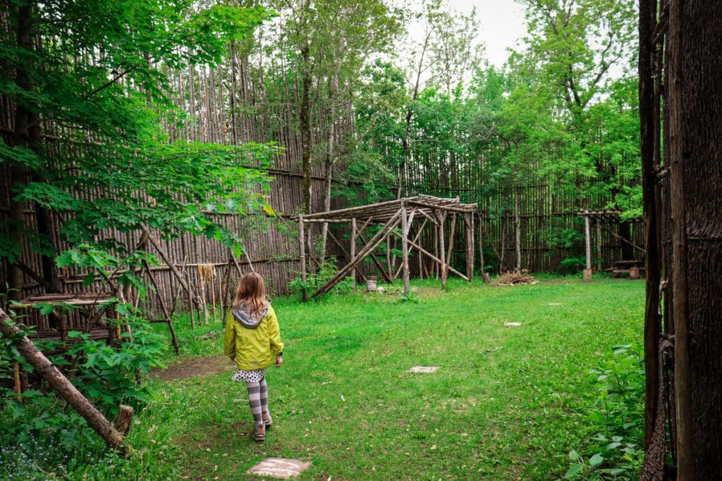 A young girl wanders the grounds of the Musée Huron-Wendat.