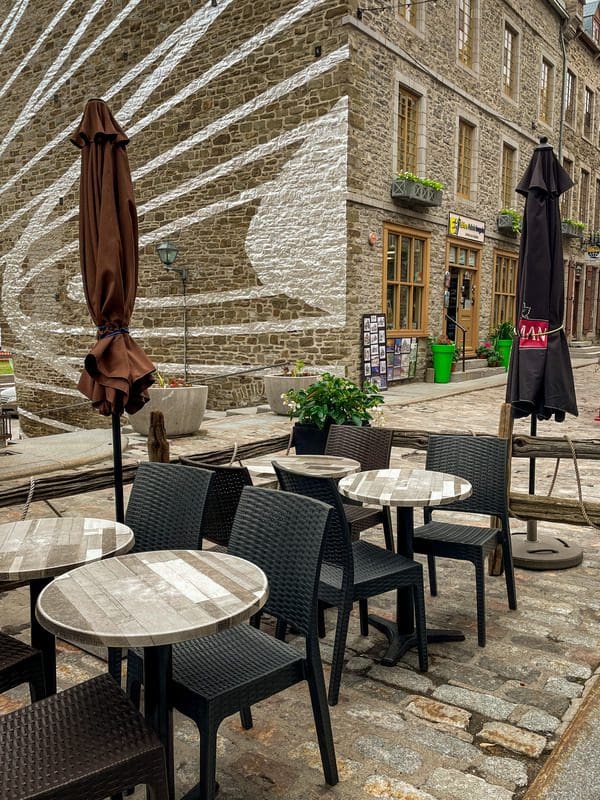 Patio seating at La Pizz Place Royale, with a view of Place Royale.