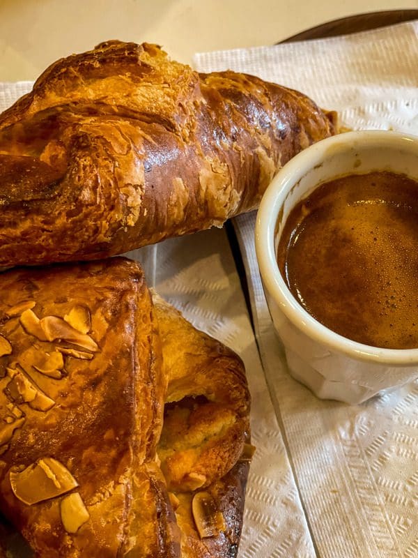 Two croissants and an espresso at Les Cafés du Soleil , a must eat on any Quebec City itinerary with kids.