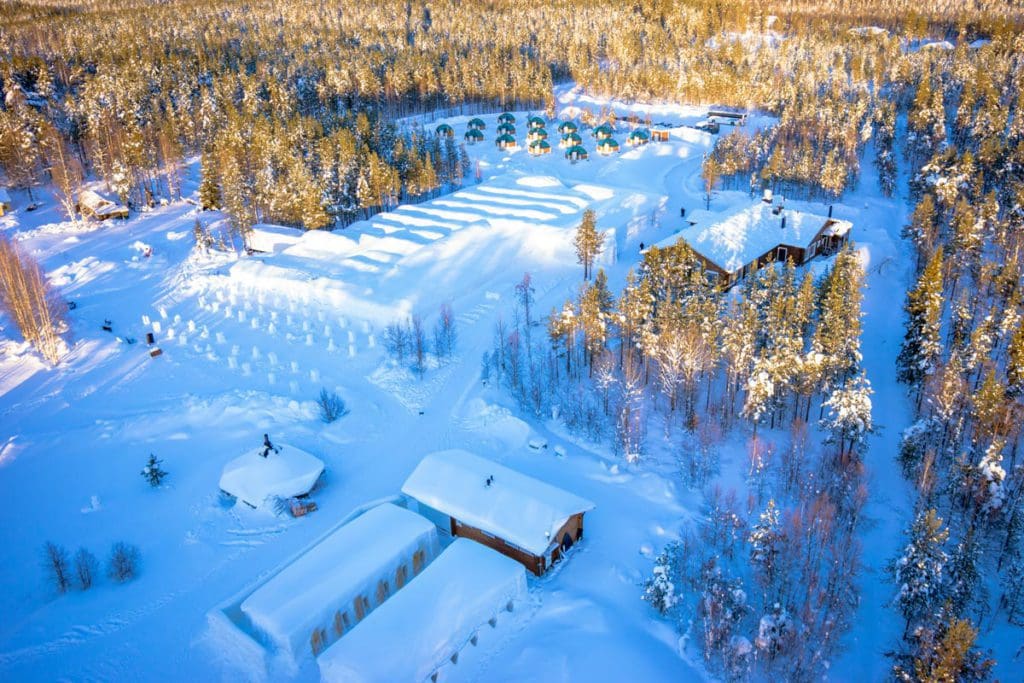A winter aerial view of the lodges at Arctic SnowHotel & Glass Igloo.