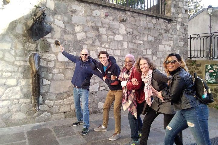 Tourists enjoy a site in Montmartre, while on the Montmartre Walking Tour: Paris’ Best Art, Culture, and Food.