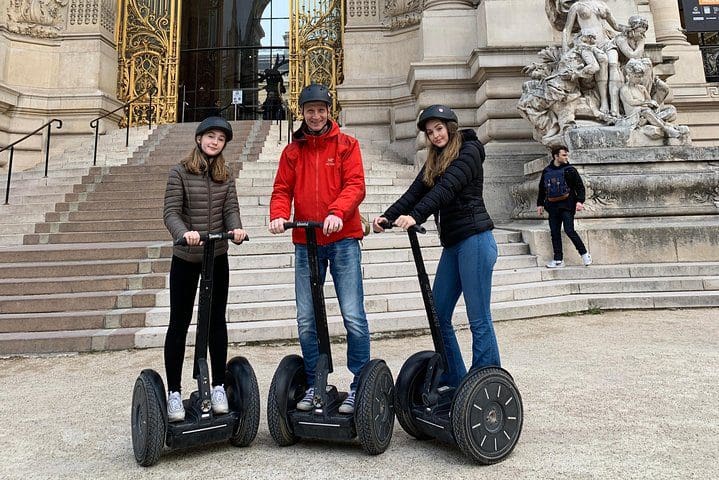 Three people on segways taking a Paris City Sightseeing Half-Day Guided Segway Tour with a Local Guide.