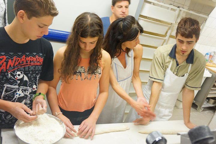 A family bakes bread together on the Paris French Bakery Behind the Scenes Experience.